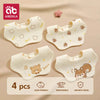 A pack of four white soft cotton gauze baby bandana bibs with bear and fruit patterns.