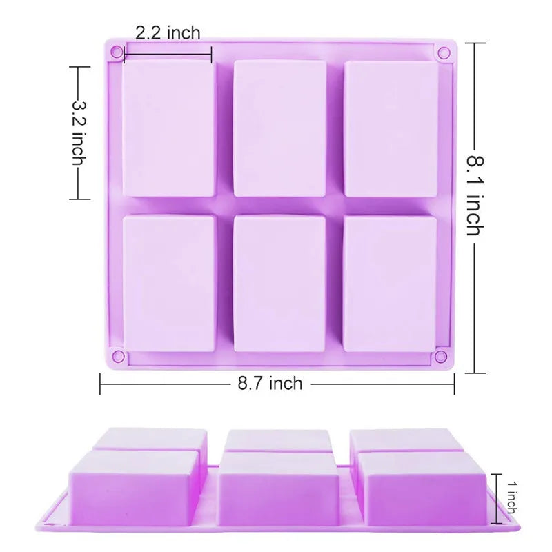 A pink silicone soap mold with six square cavities and a rectangular tray for DIY soap making.