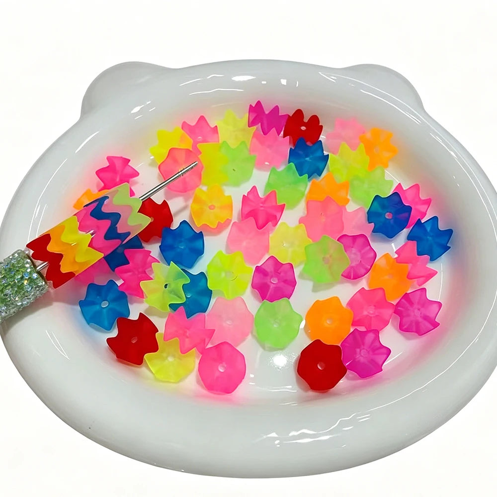 A pile of 300 translucent beads in various bright colors like pink, purple, yellow, and blue arranged in a white dish.