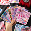 A hand holds a colorful die-cut sticker pack featuring kawaii cyber and vintage starlight designs.