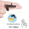 A hand holds a black finger ring launcher keychain fidget toy next to loose small soybeans and a diagram showing finger circu