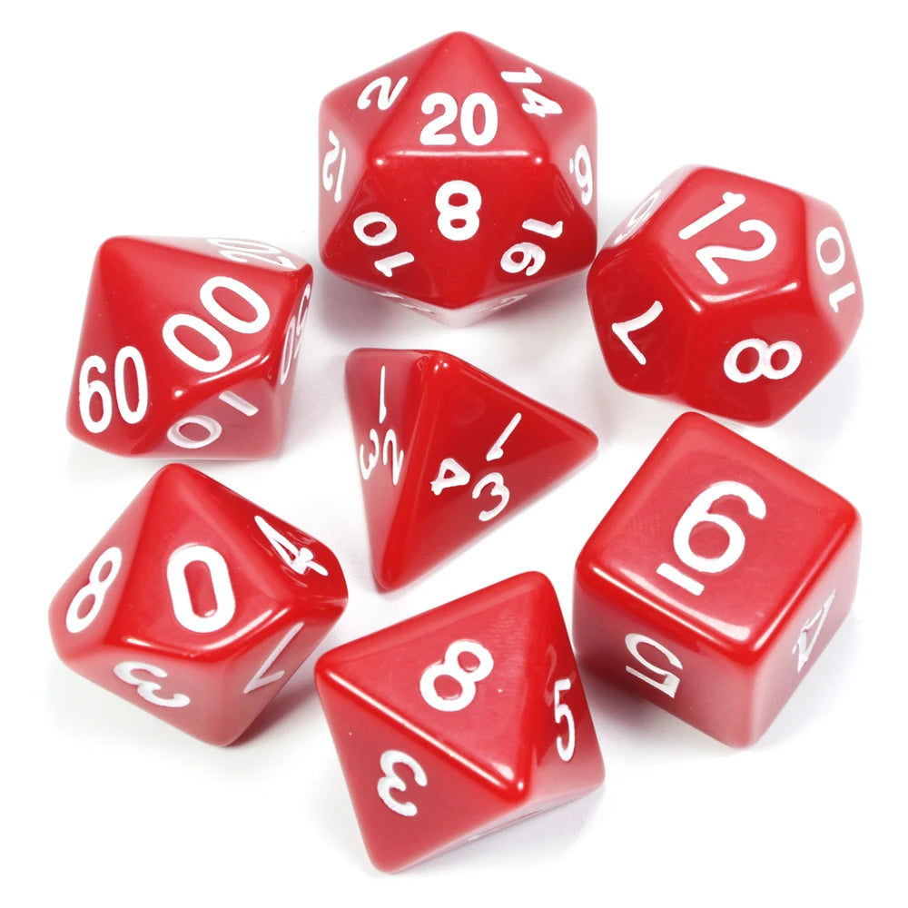 A collection of red acrylic dice, including a d20 and various numbered dice, scattered on a white surface.