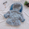 A light blue denim jacket for a child with a faux fur collar lying on a white surface.