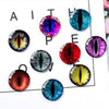 Assorted craft doll eyes with glitter finish in various colors and sizes arranged on a white background.