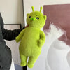 A bright lime green plush toy shaped like a cute, round alien cat with large eyes and a green nose.