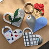 A collection of heart-shaped items made from 5mm fuse beads in various colors, including green, white, blue, and red.