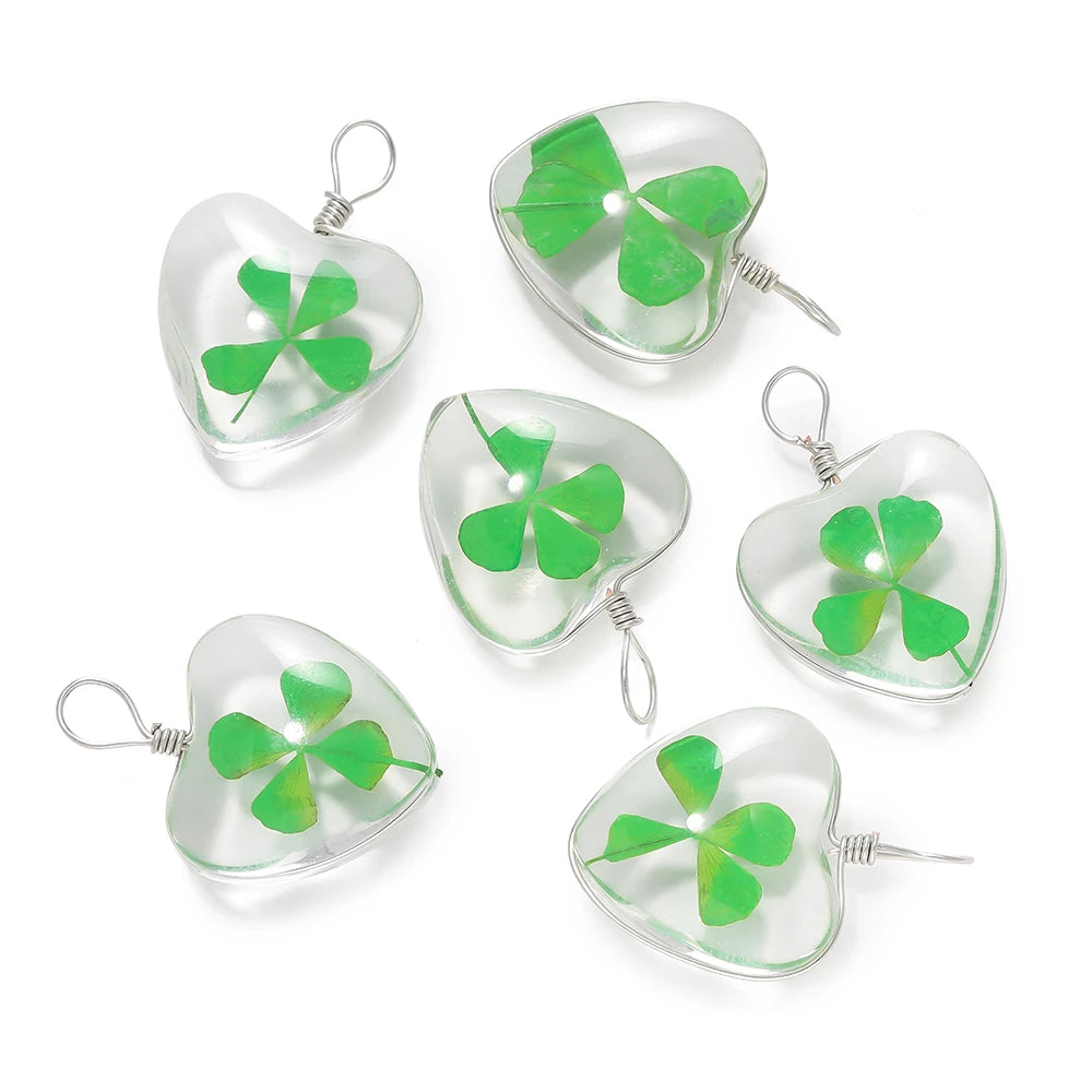 A set of three handmade glass four leaf clover pendants for jewelry making