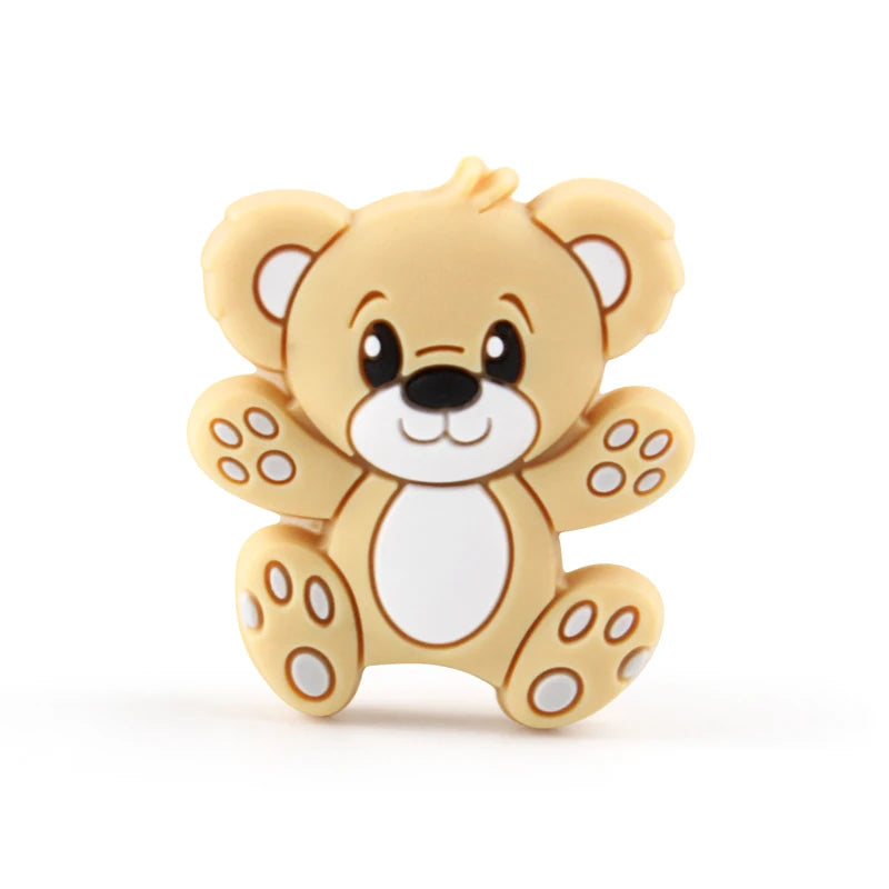 A yellow silicone cartoon bear bead with white accents and facial features.