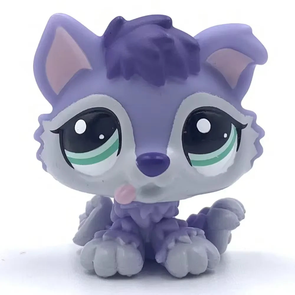 A small purple and gray pet figurine resembling a kitten or dog, with large eyes and pink accents.