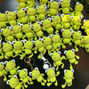 A large collection of handmade crochet frog keychains in various shades of lime green and yellow.
