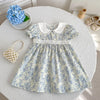 A light blue floral print dress for girls featuring bubble sleeves and a white Peter Pan collar.