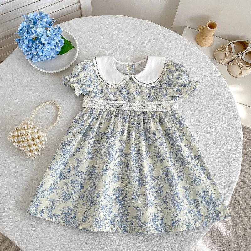 A light blue floral print dress for girls featuring bubble sleeves and a white Peter Pan collar.