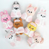 A collection of pink and white cartoon animal plush keychains and bag charms.