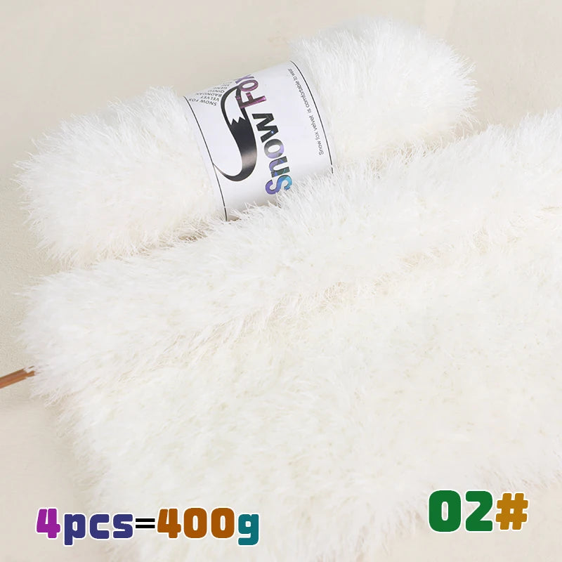 A roll of white fluffy faux fur yarn labeled Snow Fox with a wooden stick visible.