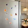 A collection of ten colorful animal fridge magnets featuring various wildlife and pets.
