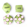 A set of green dice showing various body parts like Nipples, Toes, and Blow.