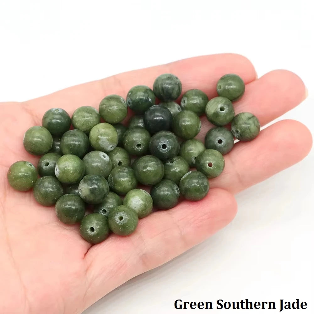 A handful of green southern jade round beads for jewelry making