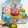 A box of glitter dumpling squishy stress relief toys in various colors and shapes.