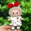 A cute plush doll dressed in a strawberry party outfit with a red bow and white dress