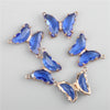 A set of gold-toned crystal butterfly charm beads for jewelry making
