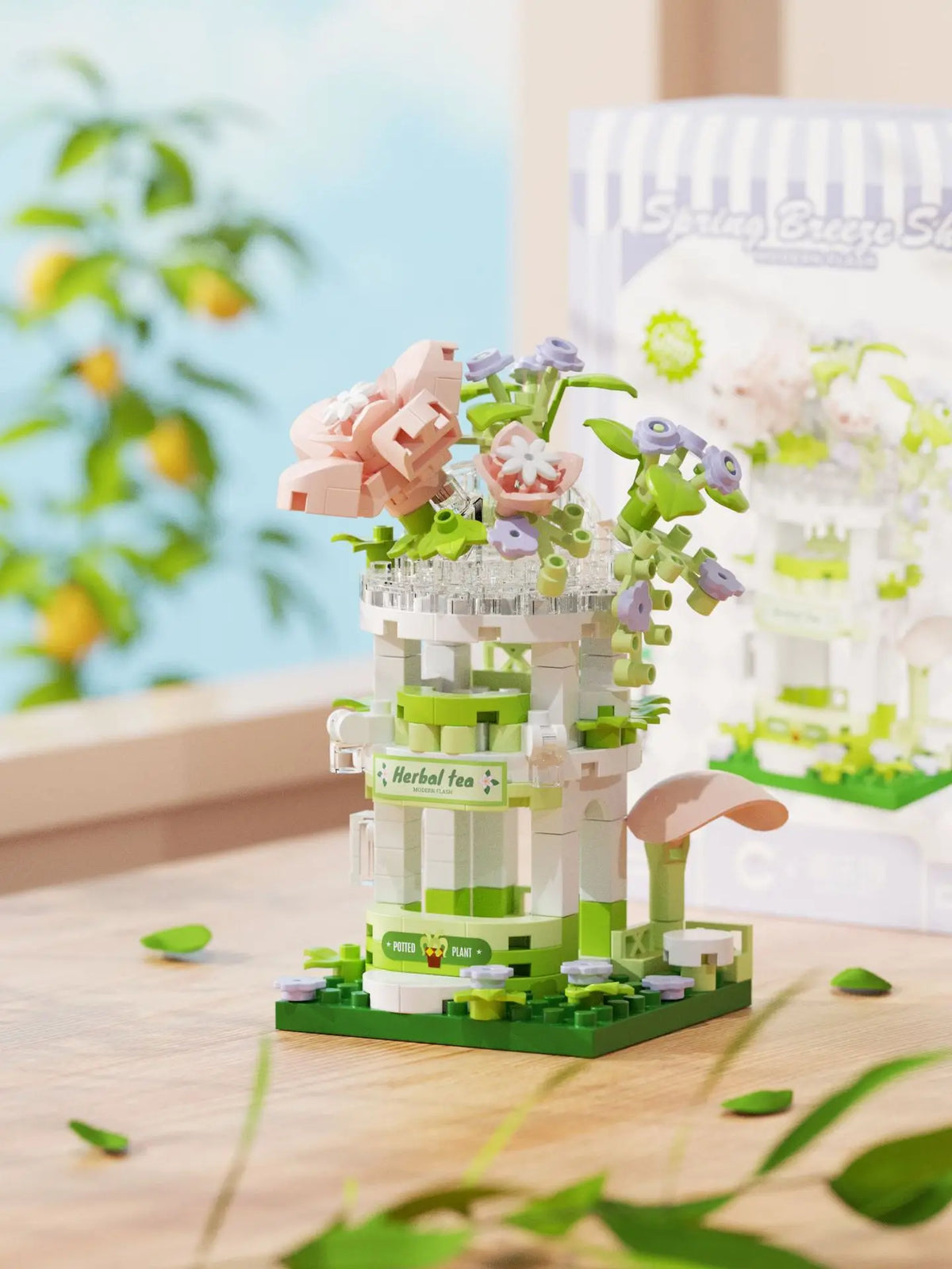 A mini building set featuring a pink and green woodland cabin and windmill structure with floral accents.