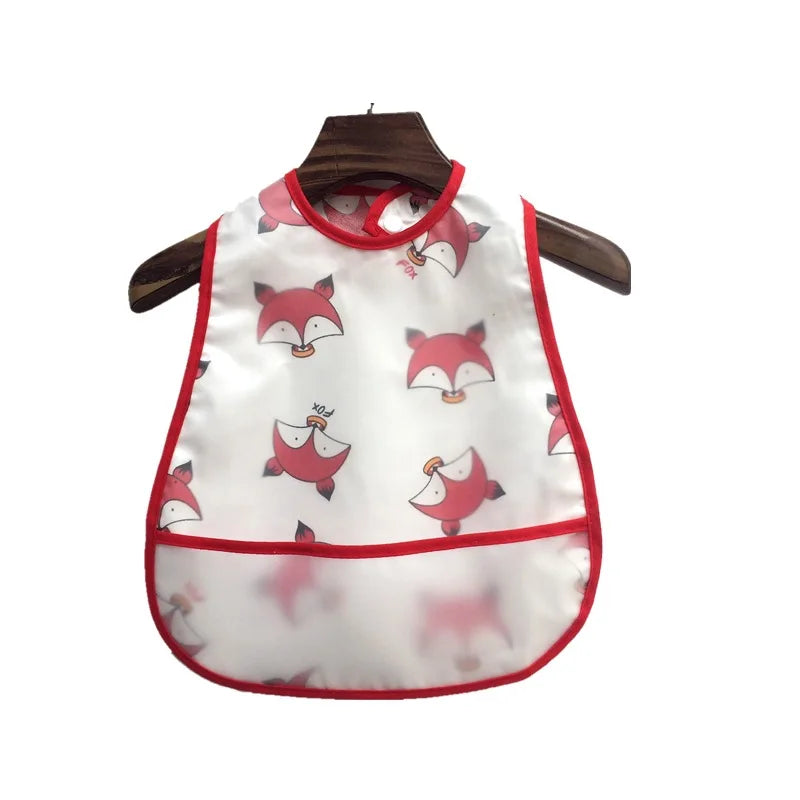 White waterproof baby bibs featuring a cartoon fox pattern displayed on a wooden hanger.