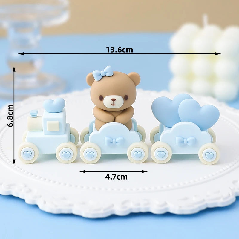 A set of cute bear-themed cake toppers featuring a teddy bear and a blue car on white and light blue backgrounds.