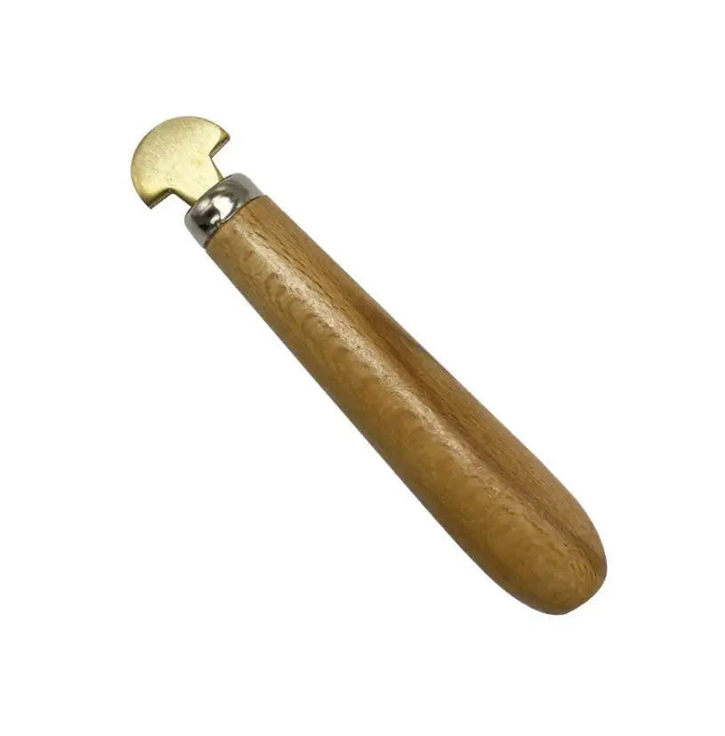 A professional bezel setting pusher tool with a brass head and wooden handle.