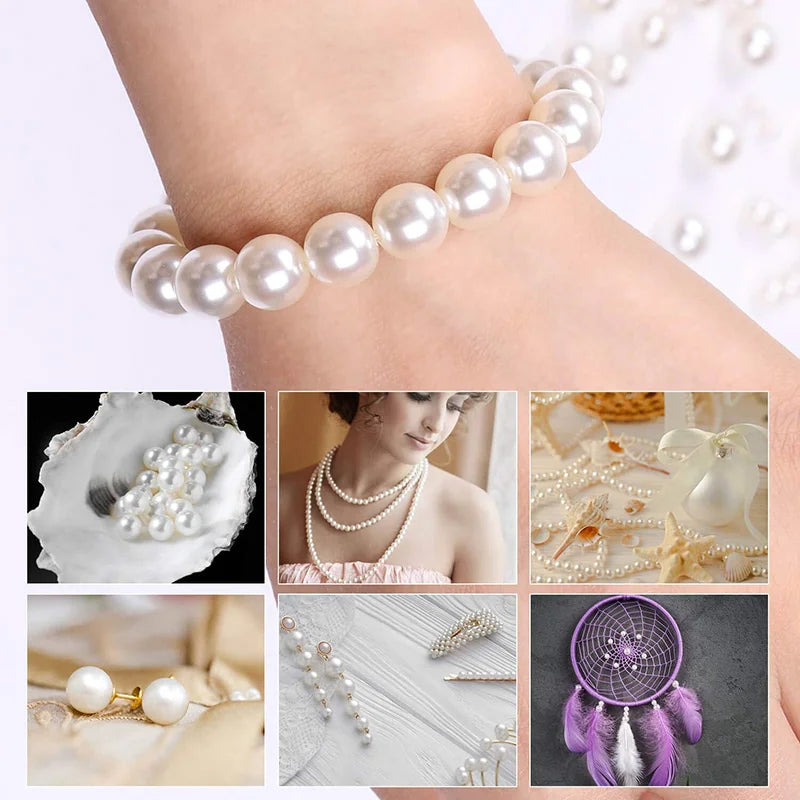 A bracelet of ivory pearl beads is worn on a wrist, surrounded by various pearl jewelry and crafting materials.