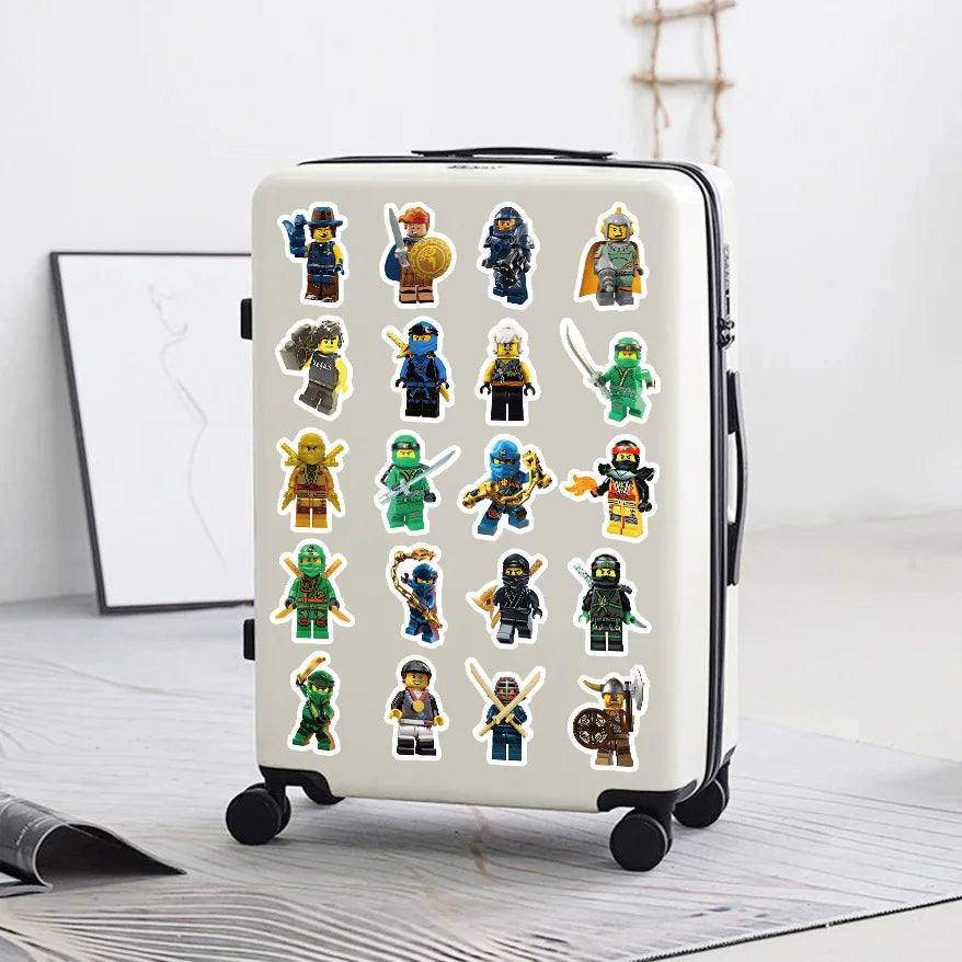A white portable suitcase features a pack of cartoon ninja stickers and decals on its surface.