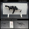 A black 1:6 scale military submachine gun model kit is displayed on a white grid, with separate brackets and scale reference.