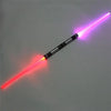 A toy lightsaber with a glowing red blade and a purple blade, illuminated against a gray background.