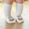 A pair of beige cartoon bear non-slip cotton socks for babies and toddlers