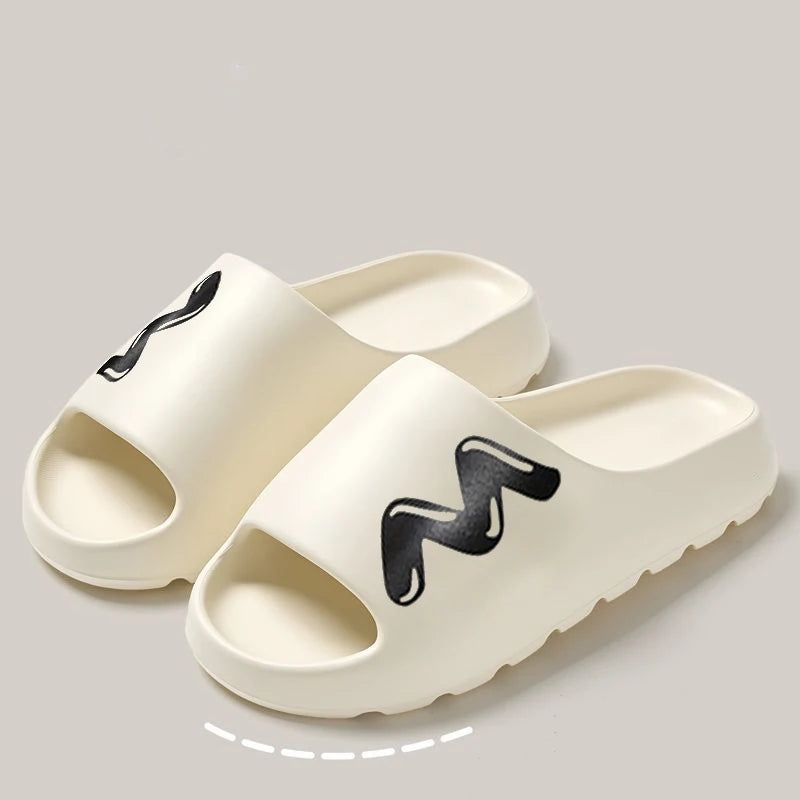 A pair of beige EVA slide slippers with a non-slip sole featuring a black wavy design.