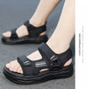 A pair of black men's non-slip summer sport sandals worn on a person's foot.