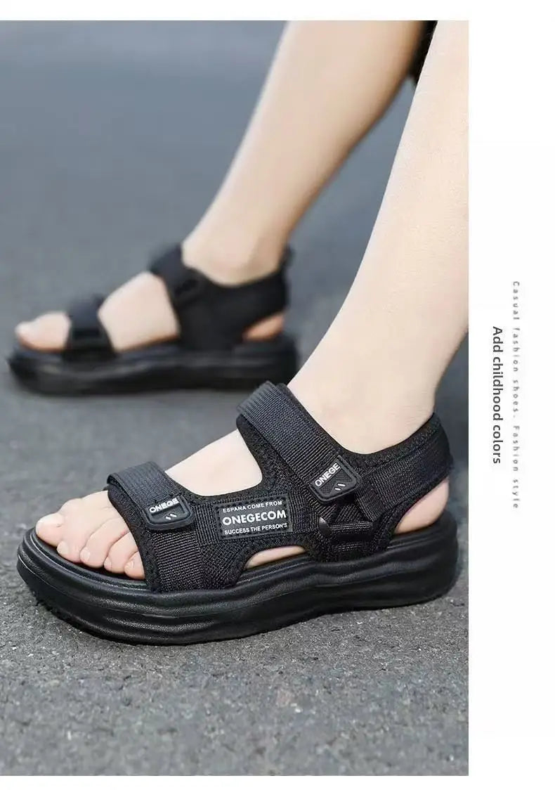 A pair of black men's non-slip summer sport sandals worn on a person's foot.