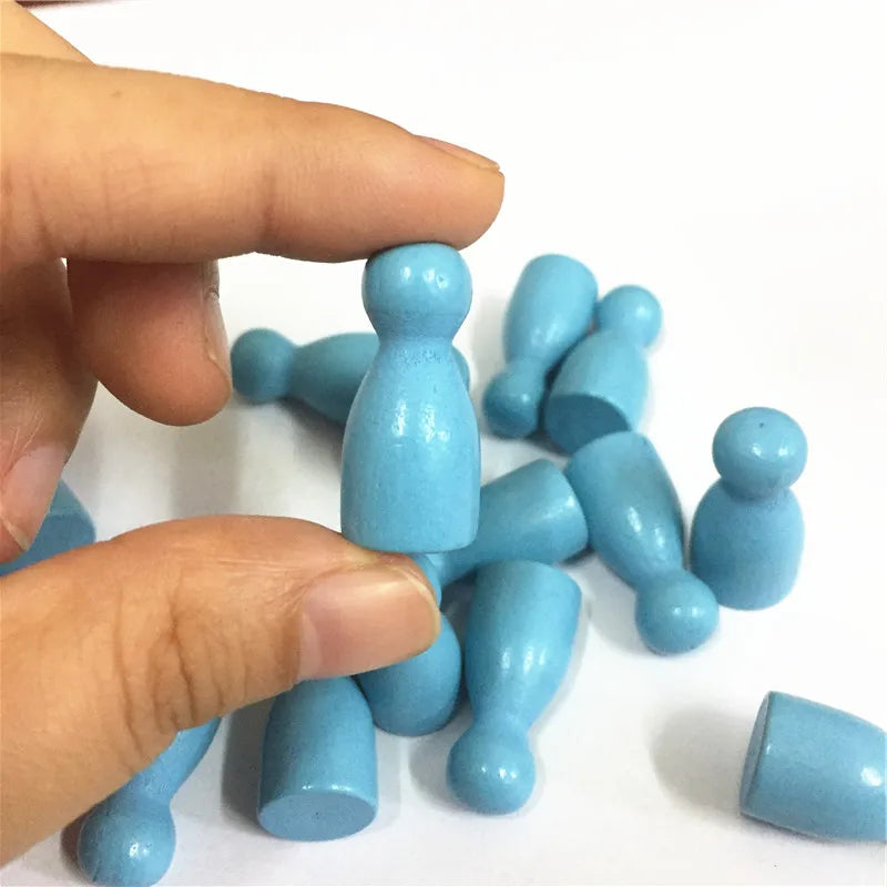 A hand holds a set of ten light blue wooden chess pawns for board games.