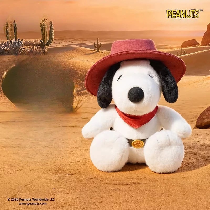 A white dog plush doll wearing a red cowboy hat and a red bandana sitting in a desert landscape.