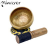 Handcrafted Tibetan singing bowl with a silk cushion and wooden mallet.