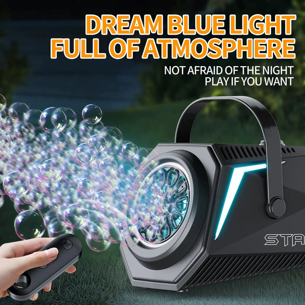 A hand operates a black rechargeable bubble machine with a remote control, creating blue light bubbles outdoors.