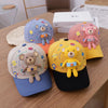 A collection of colorful toddler bear baseball caps in various shades and designs resting on a wooden table.