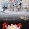 A fluffy red plush doll with white hair and large ears, featuring a decorative mask and pink accents.