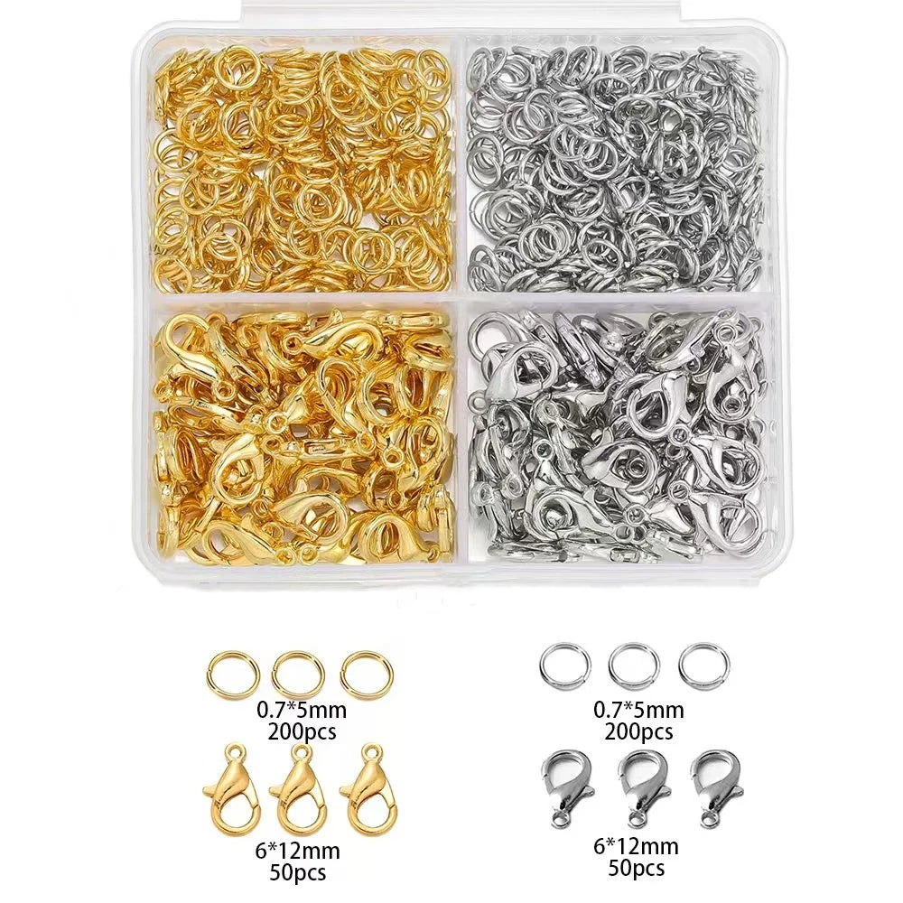 A clear plastic container holding gold and silver lobster clasps and open jump rings for jewelry making