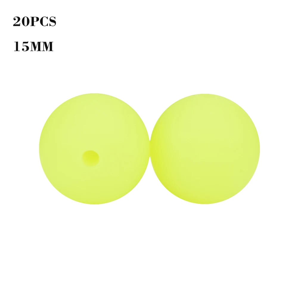 A pair of bright yellow glow-in-the-dark silicone beads, 15mm in size.