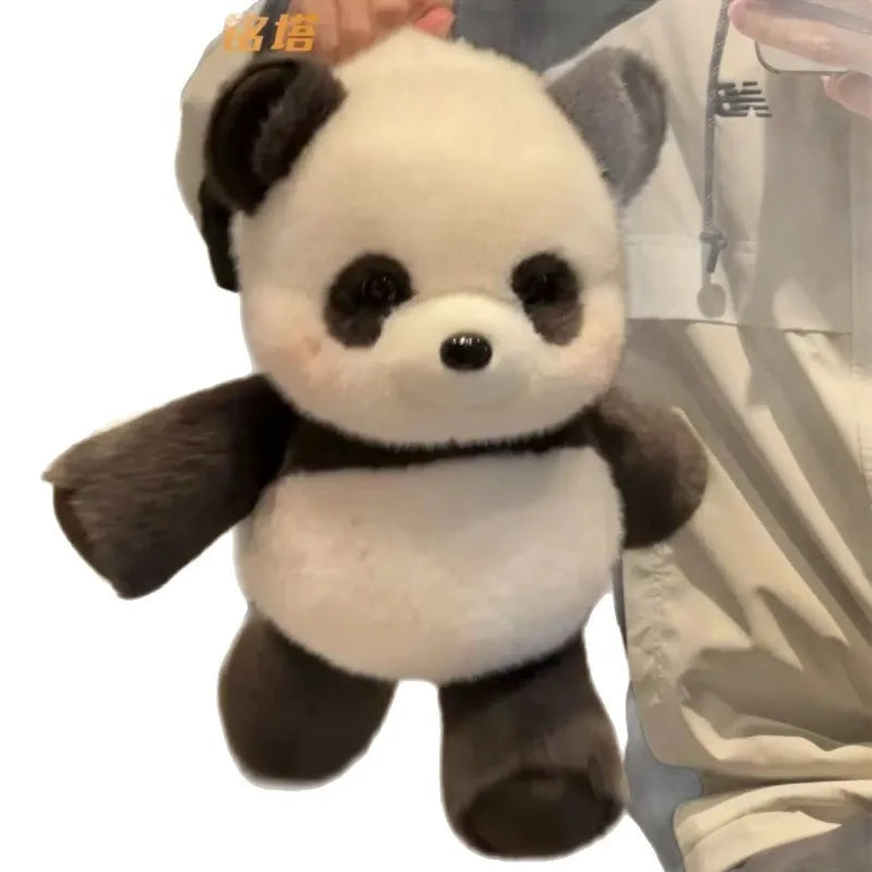 A cute stuffed panda plush toy with black and white fur, shown against a light background.