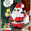 A red and white Santa figure made of micro building blocks stands next to a gift box, with a Christmas tree in the background