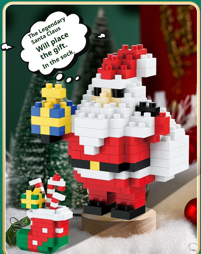 A red and white Santa figure made of micro building blocks stands next to a gift box, with a Christmas tree in the background