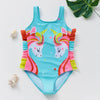 A turquoise one-piece swimsuit for a child featuring a unicorn design with pink and yellow accents.
