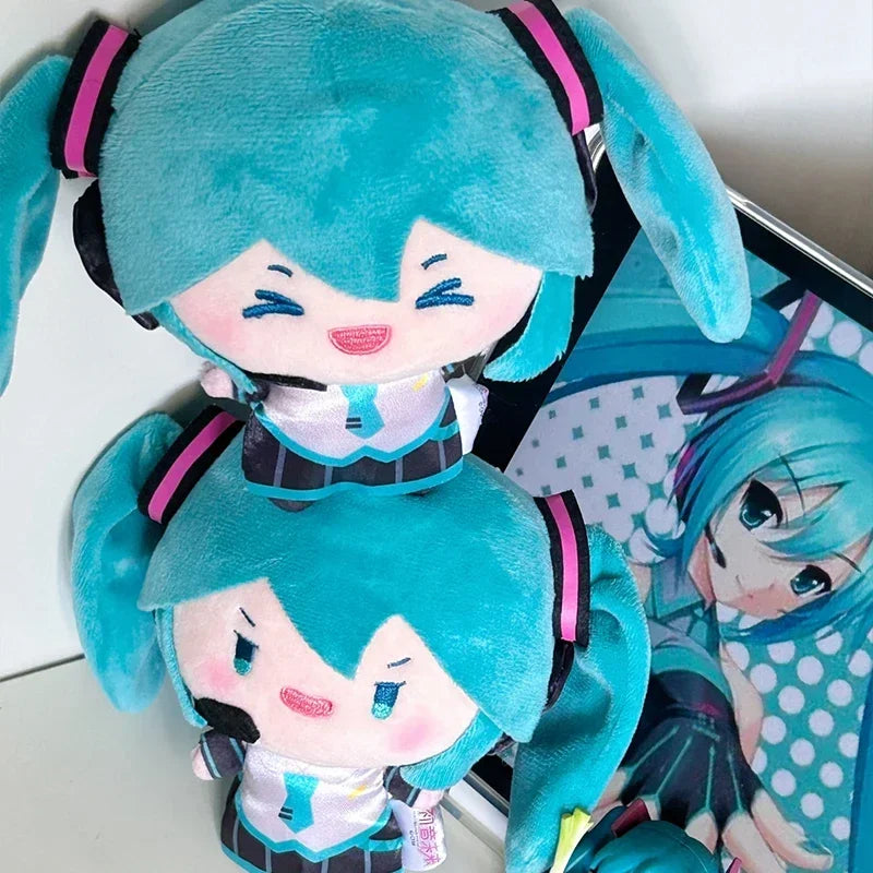 A cute teal plush doll of Hatsune Miku with black and pink accents.