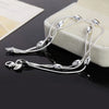 Elegant sterling silver snake chain bracelet for women displayed on a light box.